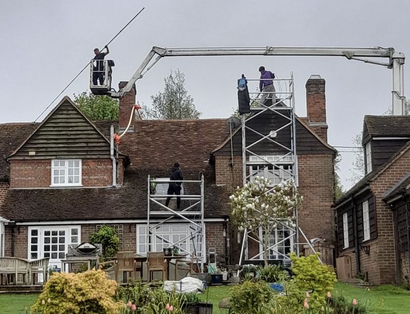 The Roof Moss Cleaners using cherry picker and scaffolding to clean roof safely and professionally in Bovingdon, Hertfordshire